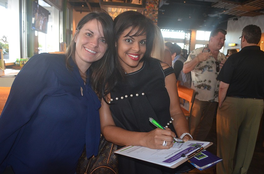 Sisterhood for Good's Breanca Niski congratulates her friend, Edna Zullin of Lakewood Ranch, as she filled out her membership application for Sisterhood for Good.