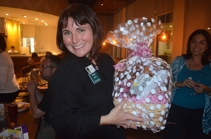 Sisterhood for Good's Laura Lynch says that she can't believe that she won a raffle item, which consisted of some wine accessories.