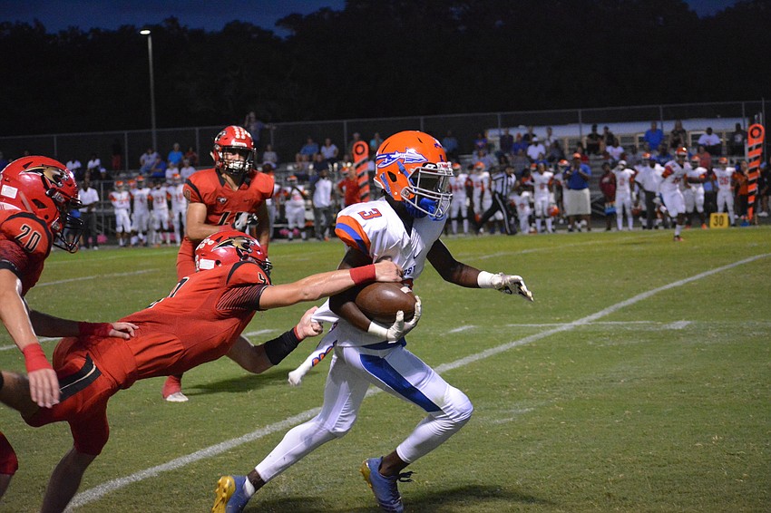 Senior defensive back Rees Swink (9) gets enough of a Southeast wideout to bring him down.