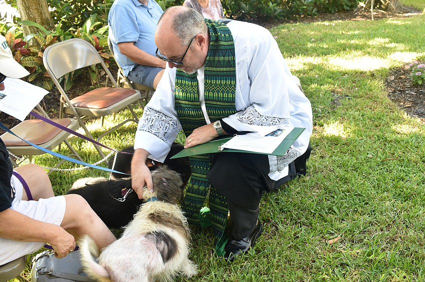 The Rev. Kenneth Blyth blesses Dolly, Jacob and Barru.