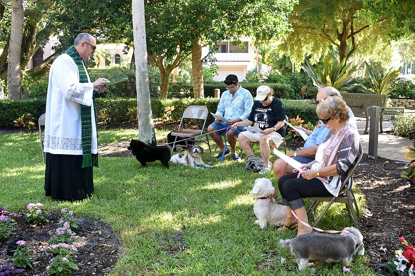 Five dogs and their owners attend a brief service for the blessing of the pets in honor of the Feast of St. Francis of Assisi, the patron saint of animals.