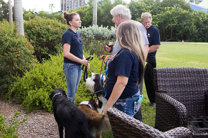 While the program goes on, Donte's Den dog handlers watch guests' dogs.