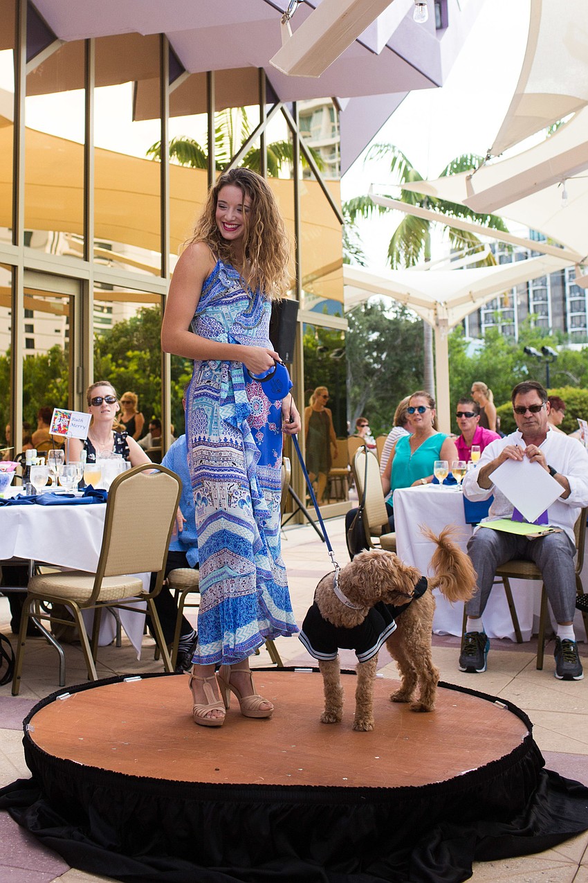 Sarah walks the runway in a design from L. Boutique with her dog Flash.