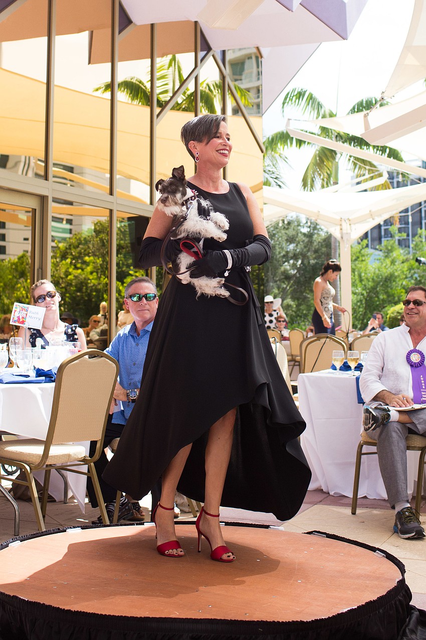Wendy Rossiter holds 4-month-old Rocco, owned by Terry McKee, who won the overall Top Dog 2018.