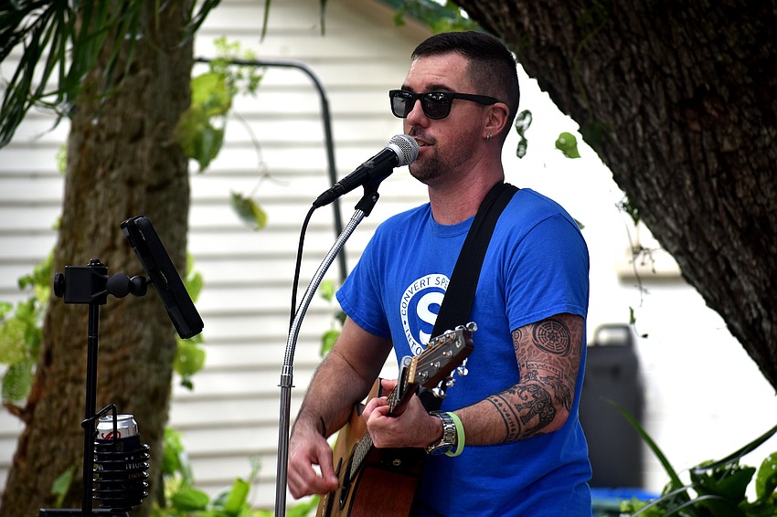 Miles Bosworth sings for a crowd during Porchfest in Arlington Park.