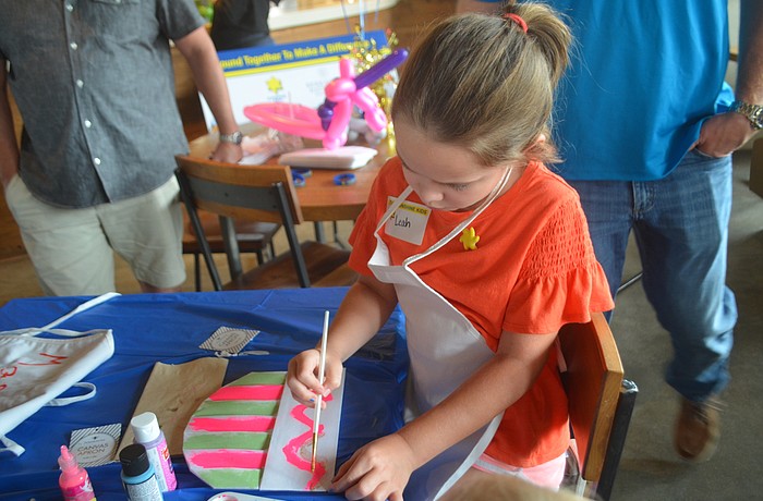 Heritage Harbour's Leah Glynn, 7, paints her chef's hat rainbow in preparation for creating her own pizza.
