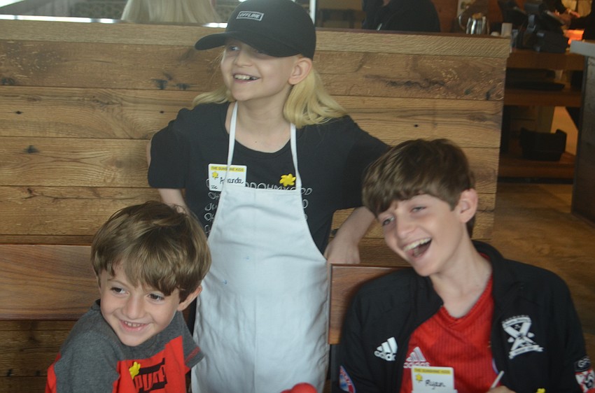 Safety Harbor's Joshua Stewart, 6, Amanda Stewart, 11, and Ryan Stewart, 13, all love to watch the balloon animals get made.