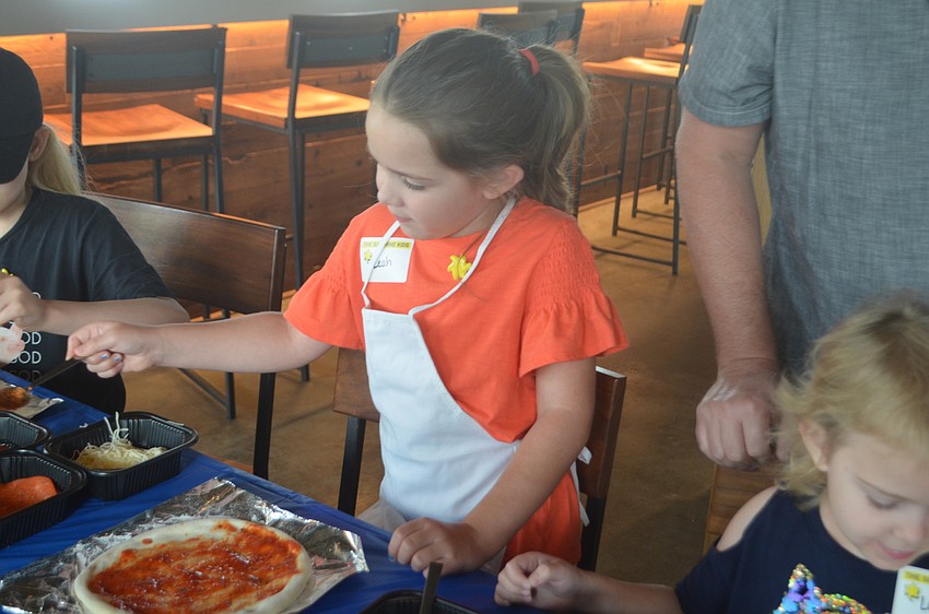 Heritage Harbour's Leah Glynn, 7,  says making her own pizza is fun, but something that she's done before.