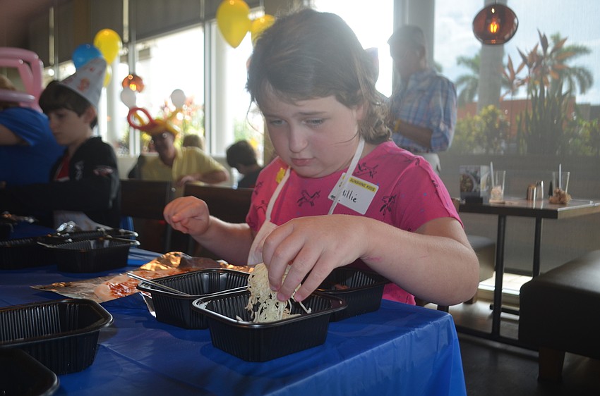 Bradenton's Millie Sica, 9, isn't quite sure how to make her own pizza, but she is interested in learning how.