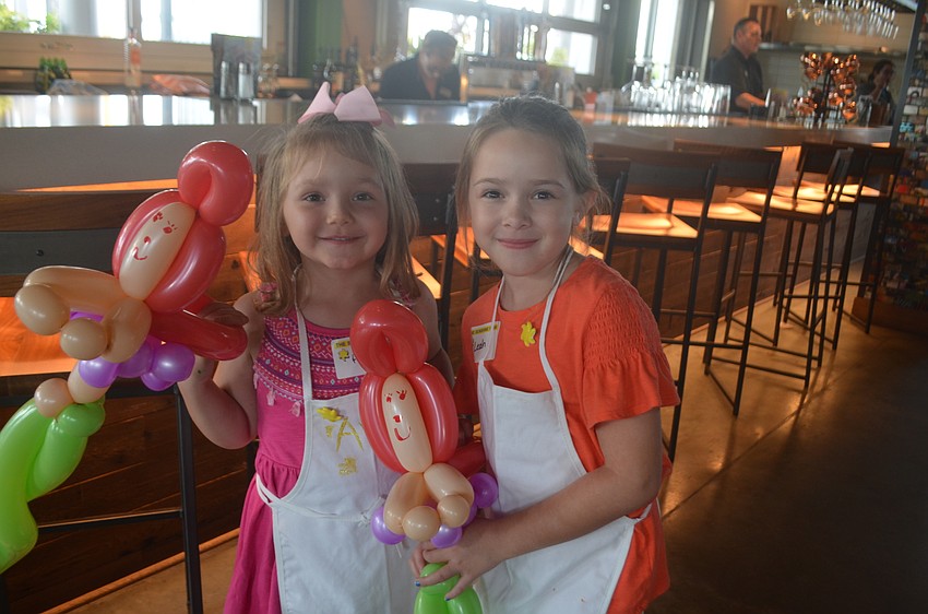 Bradenton's Ava Luciano, 4, and Heritage Harbour's Leah Glynn, 7, are excited to play with their matching mermaid balloon animals.
