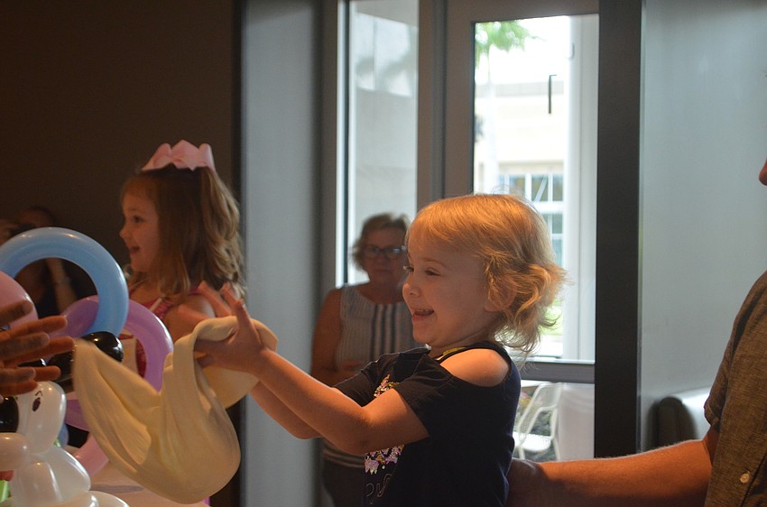 Heritage Harbour's Lauren Glynn, 5, got to throw some of the dough around with the employees of California Pizza Kitchen.