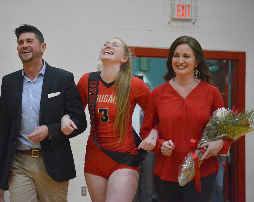 Cardinal Mooney senior Dalton Judge is escorted by parents James and Dana Judge.
