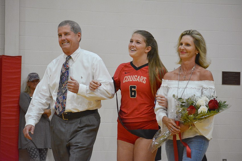 Cardinal Mooney senior Kali Plattner is escorted by parents Doug and Marci Plattner.