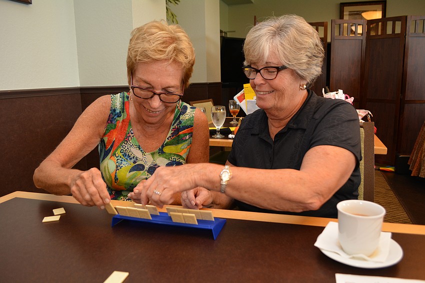 Michele Callahan and Marilyn Ballard team up to learn Rummikub together.