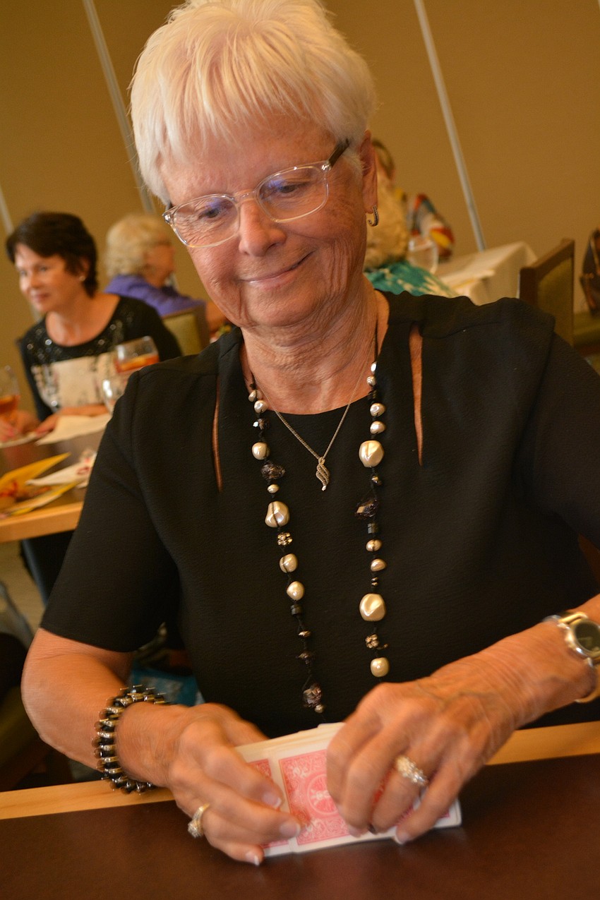 Judy Woods shuffles the deck for a game of canasta.