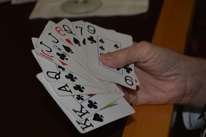 Phyllis Jameson  holds her cards close for a game of canasta.