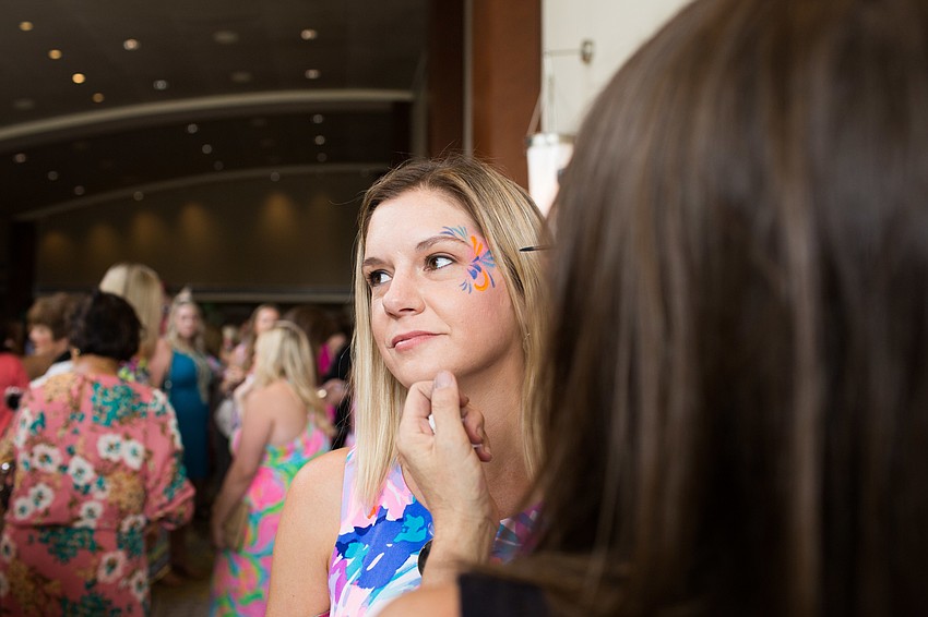 Carly Evans gets her face painted by Pixie Painting.