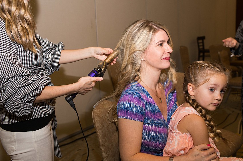 Cathi Carson and Lila Freymann get ready for the fashion show.