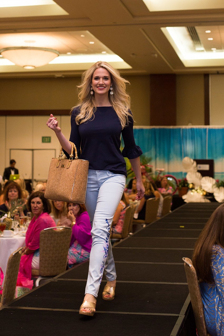 Candice Henry walks the runway with a wicker Lilly Pulitzer bag.
