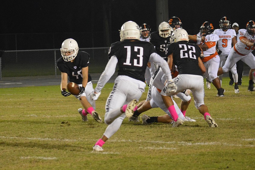 Pirates sophomore linebacker Justin Shofter (40) picks off a Sarasota pass. Shofter was called up to the varsity team earlier in the week.
