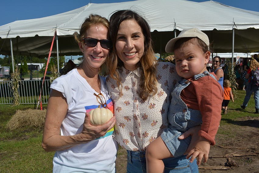 Atlanta, Ga. resident Candy Coveney  attends the festival with longtime friend Kate Pope, of St. Petersburg. Kate Pope holds her son, Milo Pope.