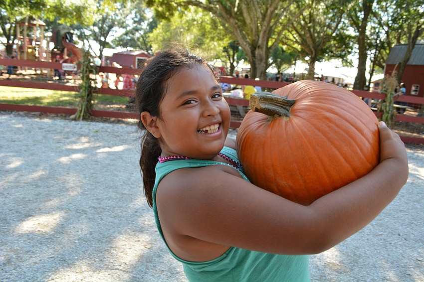 Nine-year-old Clearwater resident Samantha Sandoval is stoked about her 20-pound pumpkin and is eager to get it home.