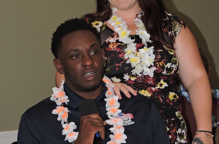 Disabled Army veteran Michael Monthervil and his girlfriend, Ashley Nickles, address the crowd at the Elks Lodge during a fundraiser for Homes for Our Troops.