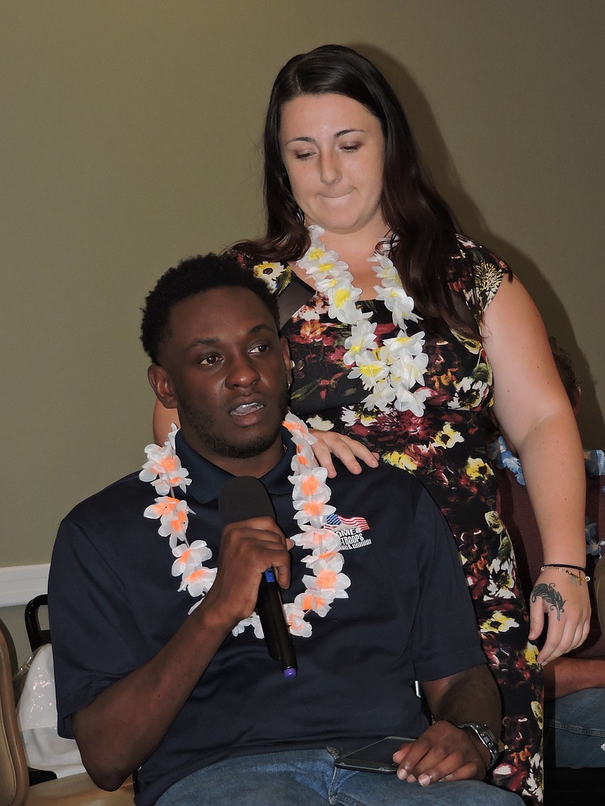 Disabled Army veteran Michael Monthervil and his girlfriend, Ashley Nickles, address the crowd at the Elks Lodge during a fundraiser for Homes for Our Troops.