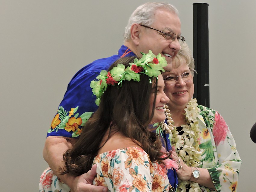 Sienna Grace Zwizinski, who played her ukulele for the crowd, visits with Chuck and Phyllis Stolteben, who donated their entertainment services to the event.