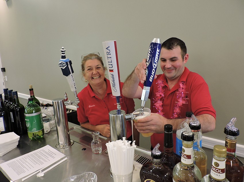 Laurie Nichols and her son, Kevin Nichols, work the event as bartenders. Laurie Nichols said Gold Coast Eagle Distributing donated tap equipment and was a major reason the event was a success.