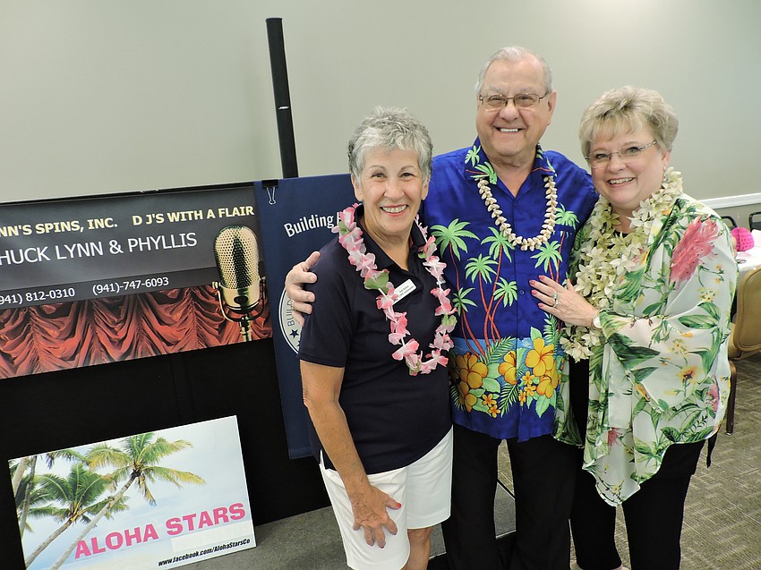 Rosedale's Deb Kehoe visits with Chuck and Phyllis Stolteben of Lynn's Spins, which provided musical entertainment.