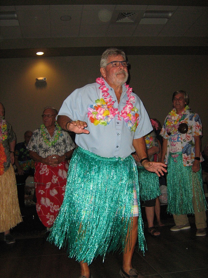 Elks member Larry O'Connor gets into a grass skirt and does a hula dance to benefit Homes for Our Troops.