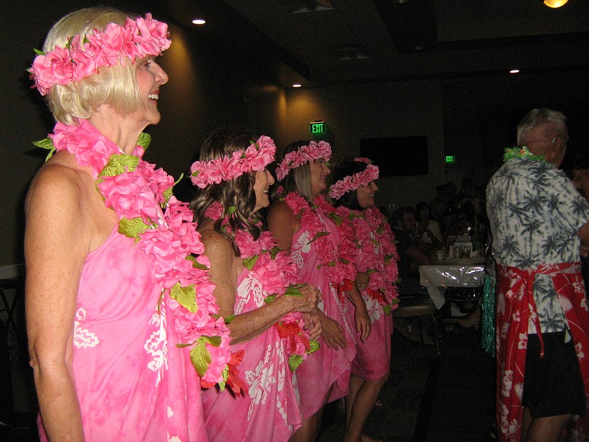 The real dancers watch Elks members perform in the hula dance contest.