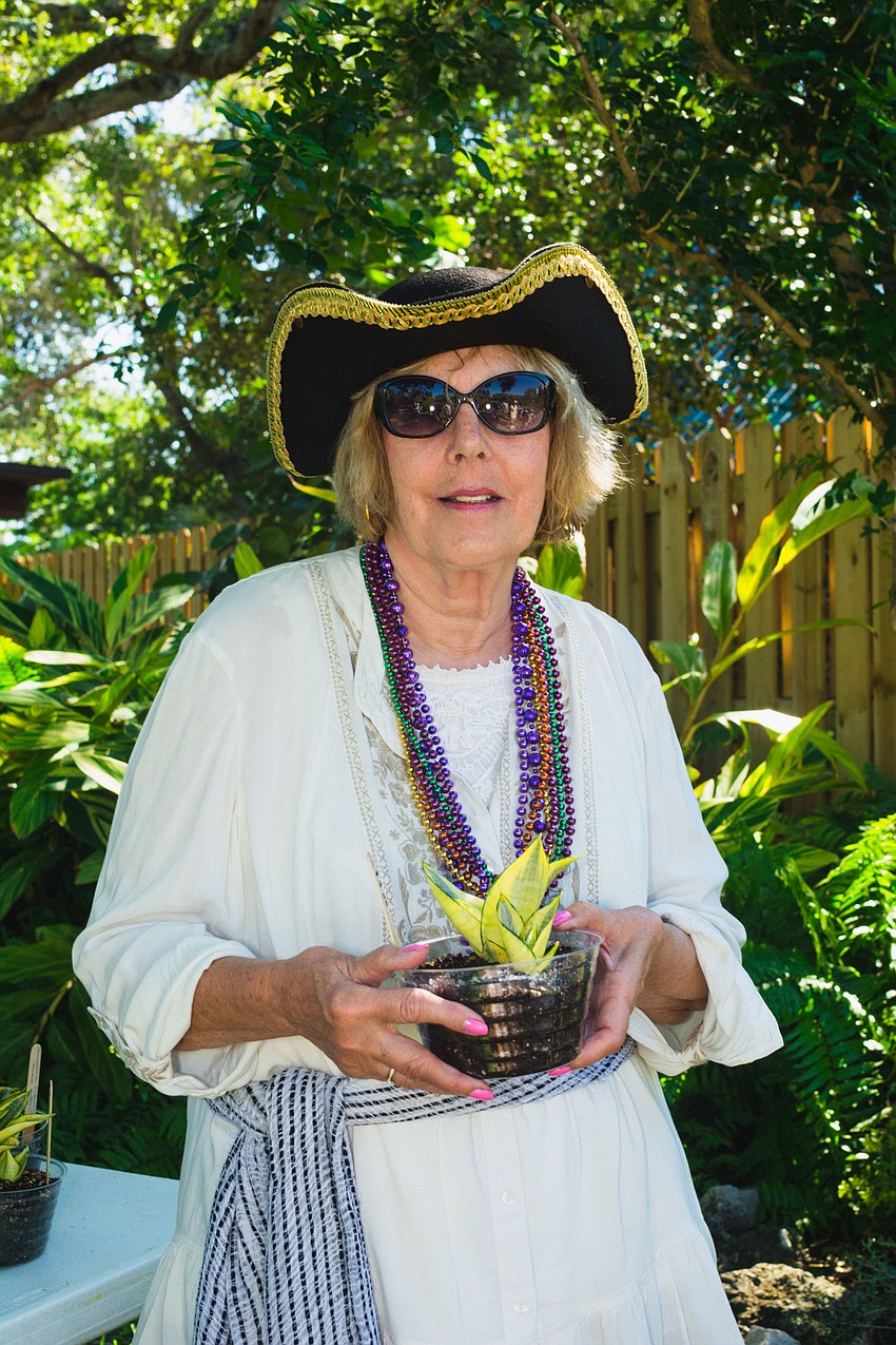 Phyllis Lasky shows of a sanseveria plant.