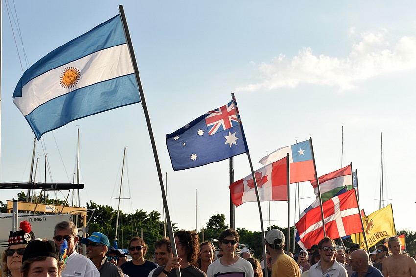 At the beginning of the opening ceremony, the sailors paraded their flags around the Sarasota Sailing Squadron.