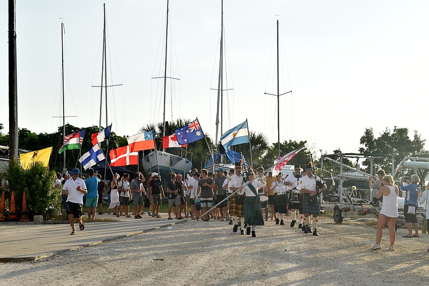 At the beginning of the opening ceremony, the sailors paraded their flags around the Sarasota Sailing Squadron.