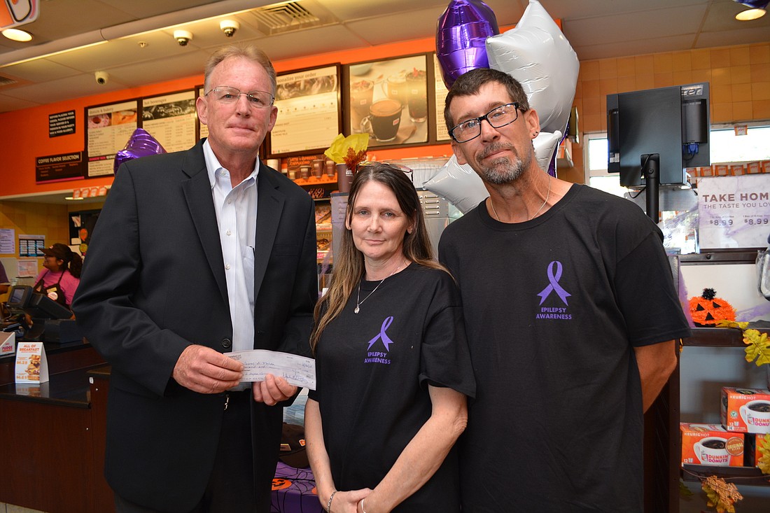 Kevin Lindberg, executive director of the foundation, accepts a check from Dunkin&#39; Donuts in honor of Alyssa Varner, daughter of Myakka&#39;s Melissa and David Howell.