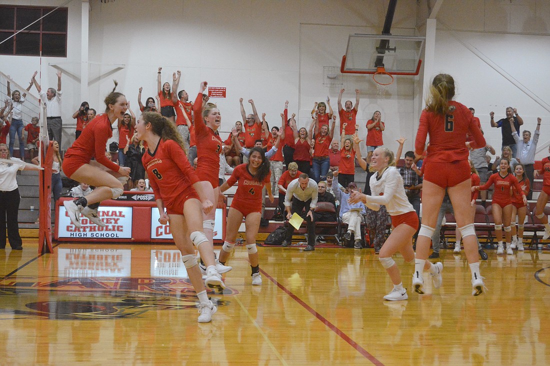 The Cougars explode after the match&#39;s final point, which game them the win.