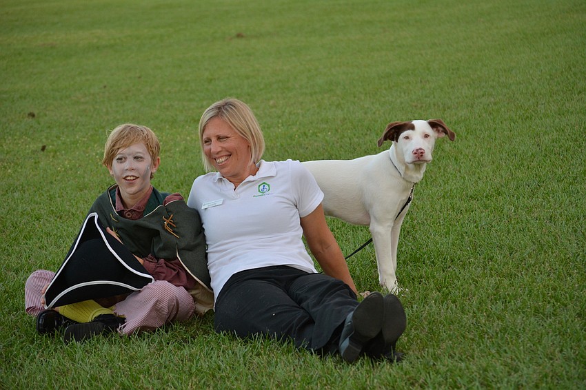 Joseph Bahan and his mom Melissa Eeftens, with Calvin, enjoy the show from the field, rather than sitting in chairs.