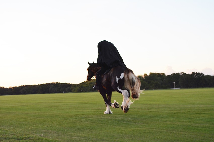 The Headless horseman (Carmen Hanson) rides across the polo fields at the end of the performance.