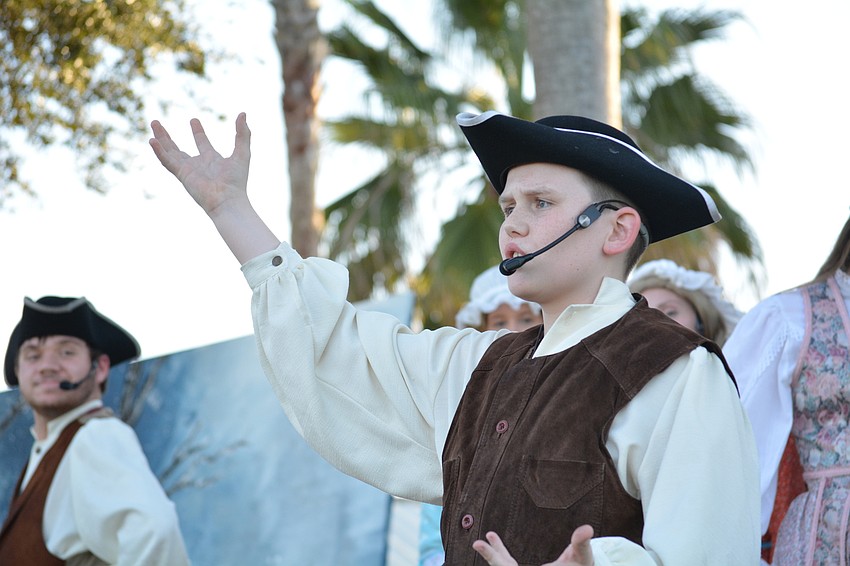 Yost, played by Auggie Toynton, announces the strength of his friend Brom Bones in an effort to impress the girls.