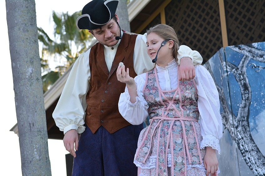 Brom Bones  (Nathan Turoff) gives a special coin to the girl he wants to marry, Katrina Van Tassel, played by Alexandra Cavanaugh.