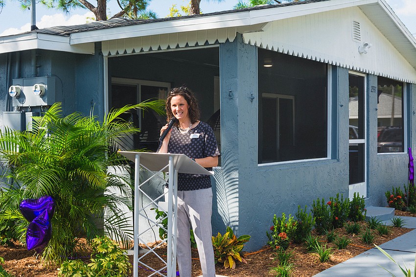 Harvest House Executive Director Erin Minor speaks at the ribbon-cutting ceremony.