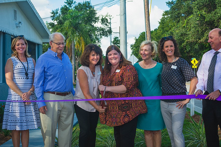 Harvest House team members and other partners involved cut the ribbon during the dedication ceremony.