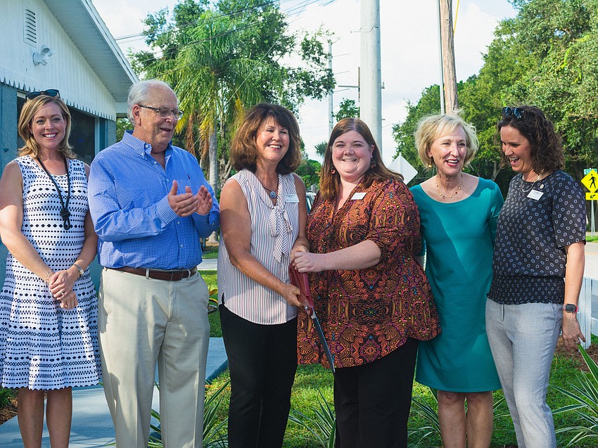 Harvest House team members and other partners involved cut the ribbon during the dedication ceremony.