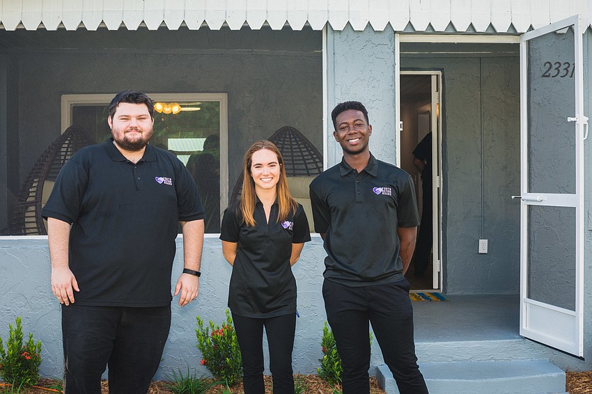 Members of Harvest House's Youth Action Board Jason Whittenburg, Katherine Powell and Daryll Williams in front of the new drop-in center.