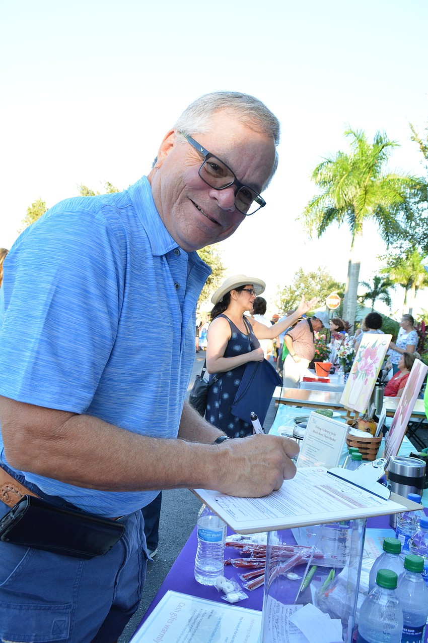 Andrew Hertzfeild gets his Manatee County library card and signs up for the new Friends of the library group, created to support the library being planned in Lakewood Ranch.