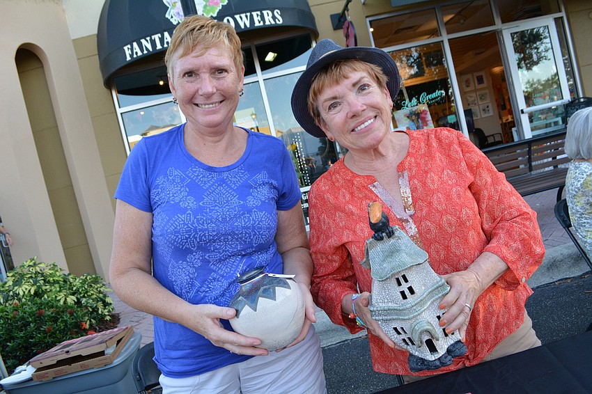 Wilma Kroese and Sue Kerr show off pieces through their club, the Creative Arts Association, which will hold an art show in November.