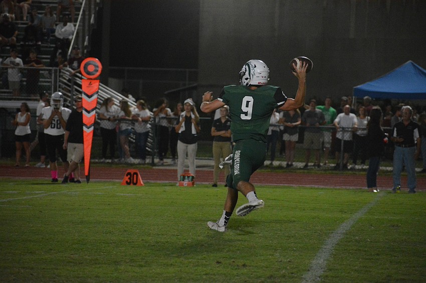 Mustangs senior quarterback George Davis launches a pass downfield.