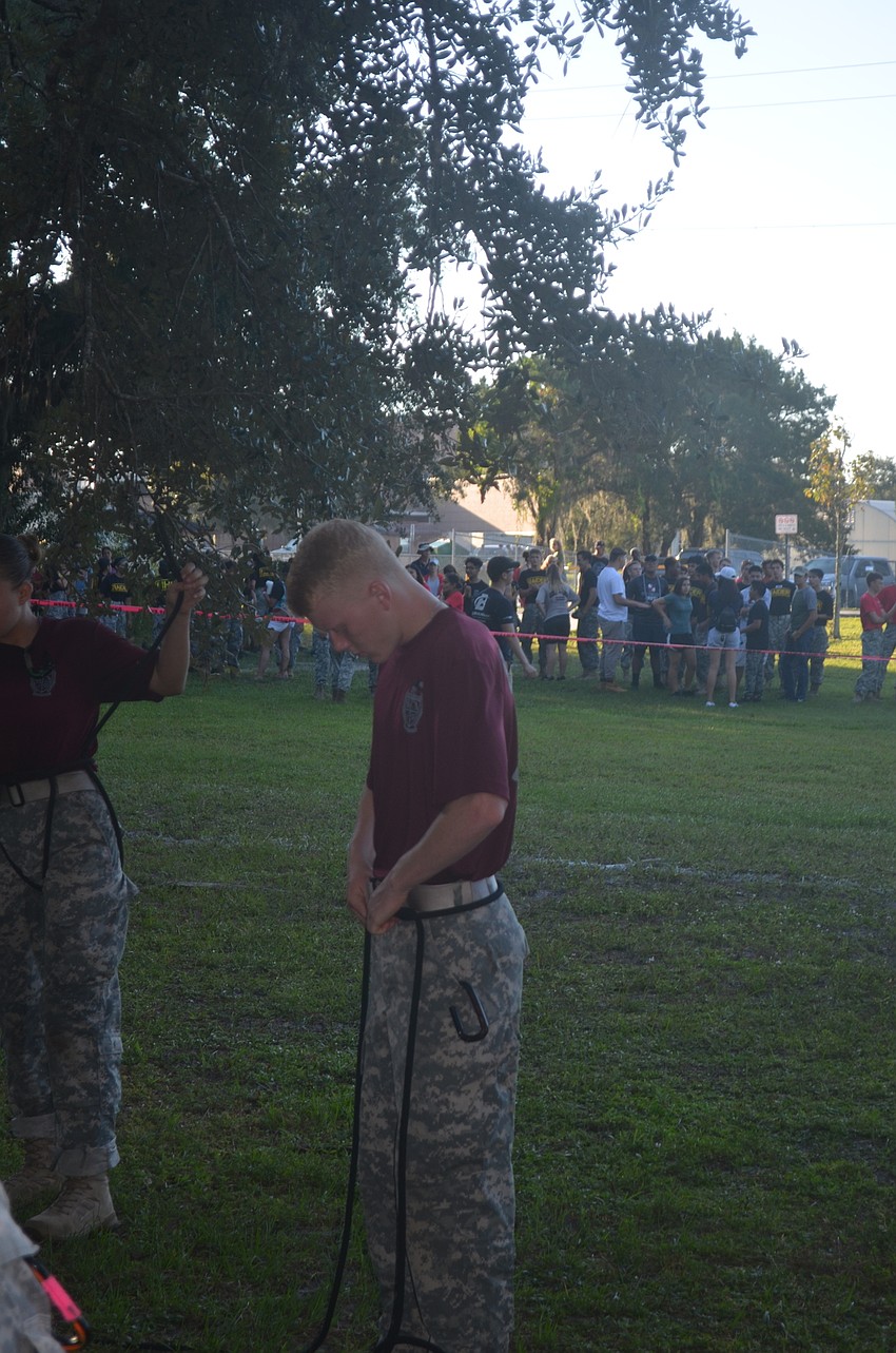Junior Reed Blankinship from Braden River, has to tie his knot exactly correct before his team pulls him across the rope bridge so he doesn't get a penalty, which can be a little nerve-wracking.